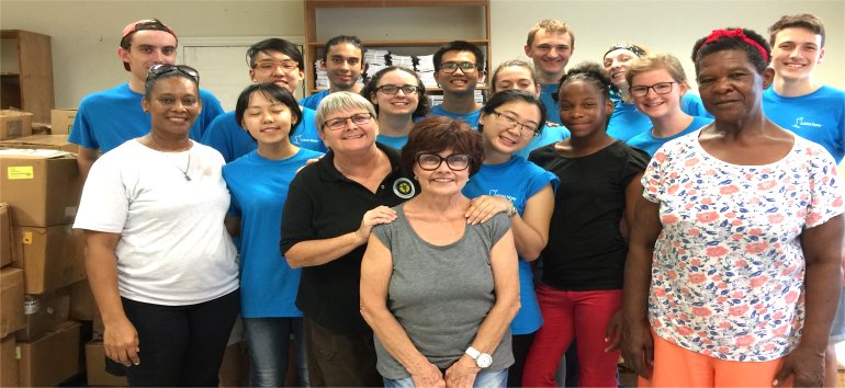 Logos Hope volunteers pack Love Packages shipped to Barbados for the churches of Dominica donated by Eagles Nest Ministries