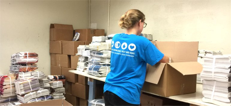 Logos Hope volunteers pack Love Packages shipped to Barbados for the churches of Dominica donated by Eagles Nest Ministries