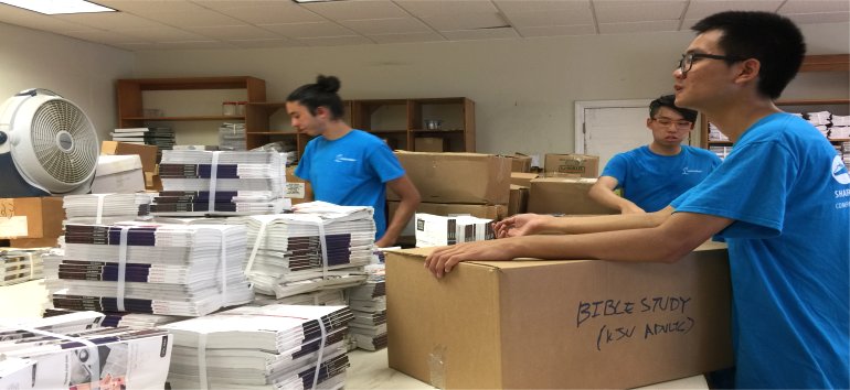 Logos Hope volunteers pack Love Packages shipped to Barbados for the churches of Dominica donated by Eagles Nest Ministries